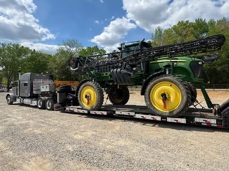Farm Equipment loaded on truck John Deere Sprayer - large farm equipment - loaded onto truck for port