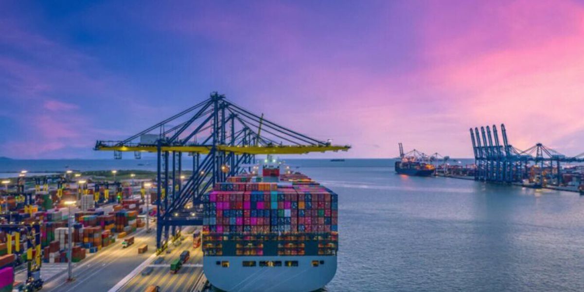 Cargo ship being loaded at dock - Texas Freight Forwarder 