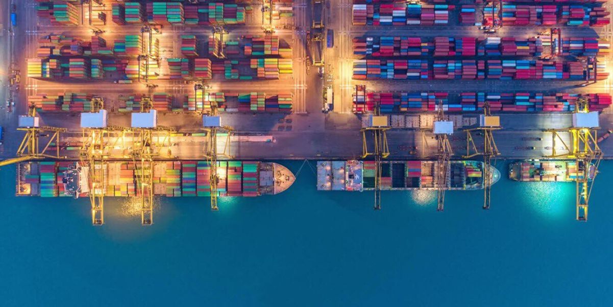 overhead shot of ships loading at dock - International Freight Forwarder